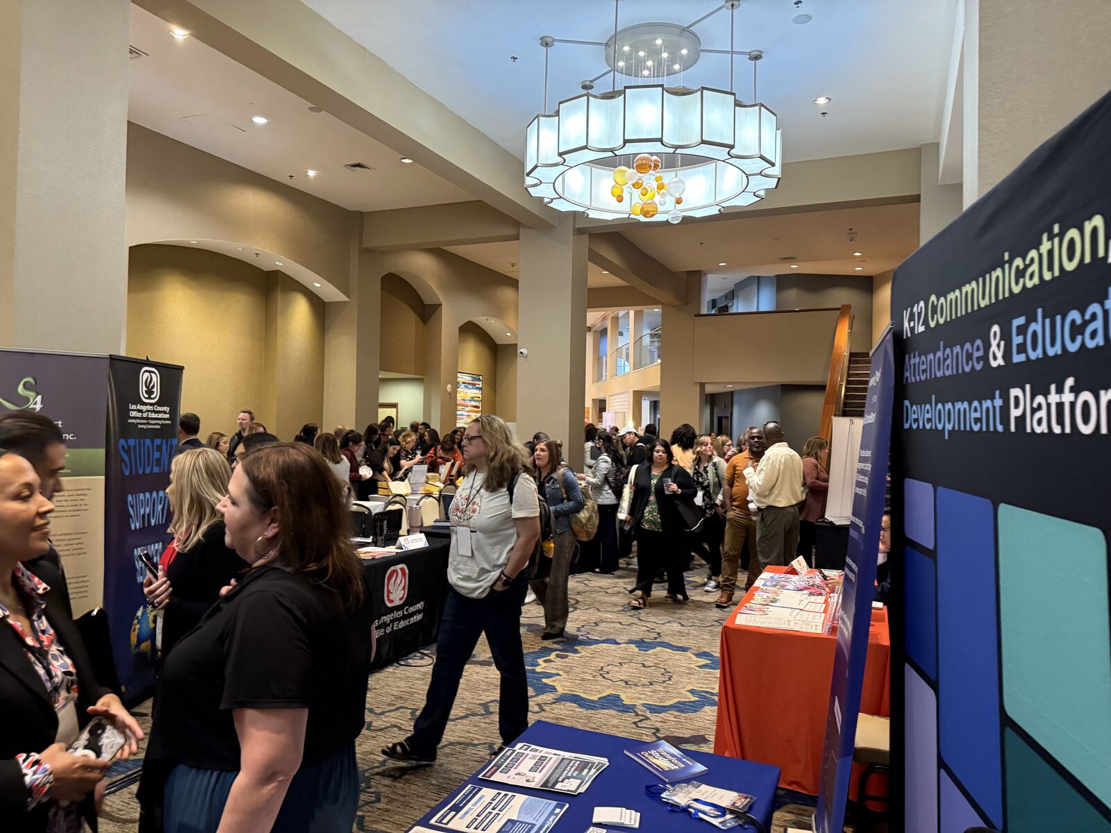 Educators walking and connecting in the exhibit hall at the CASCWA 2025 conference