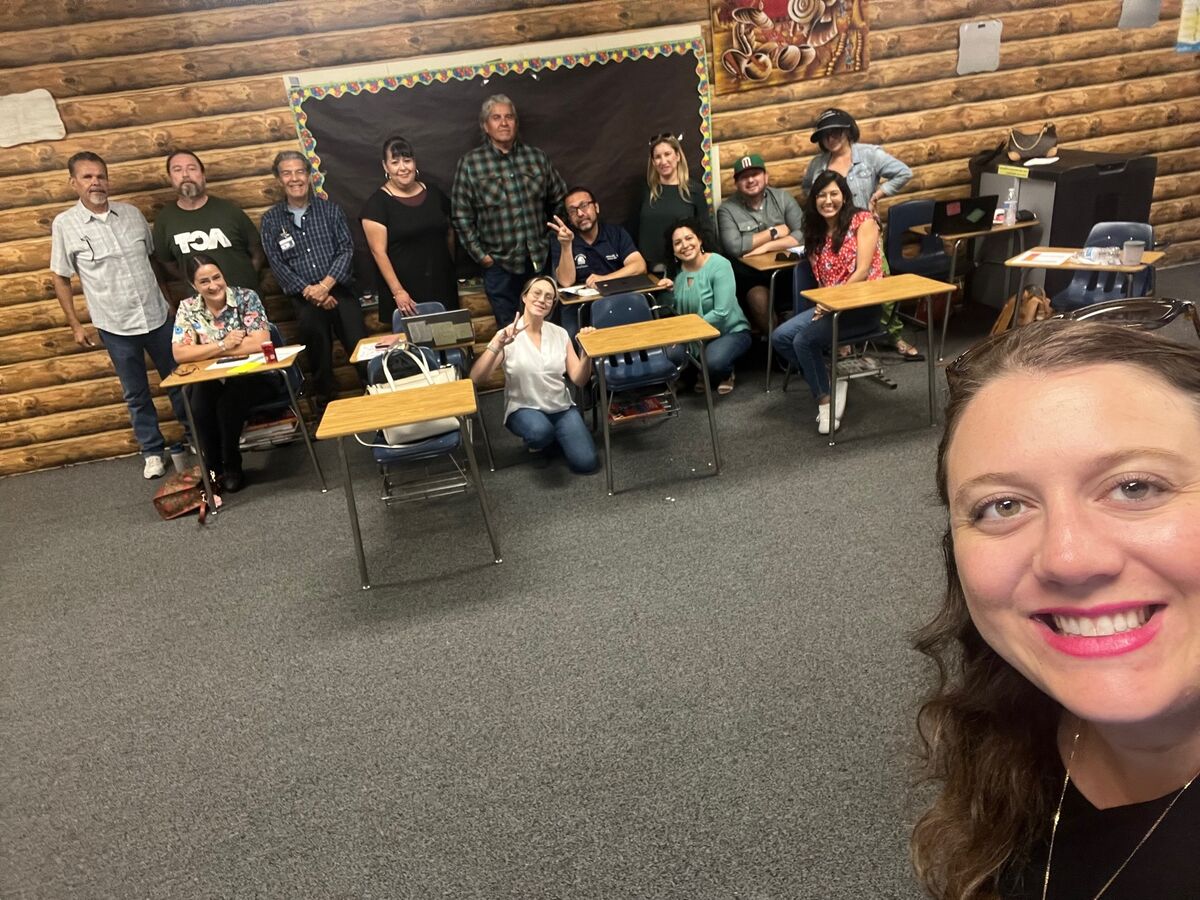 Jessica taking a selfie with a site team during a working session